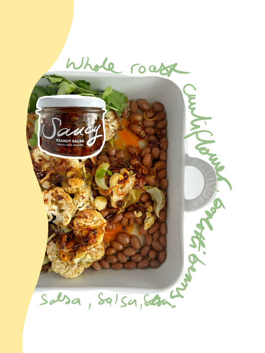 Roasted cauliflower steaks served with borlotti beans and peanut salsa, alongside a jar of Saucy sauce